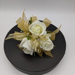 white roses with gold ribbon