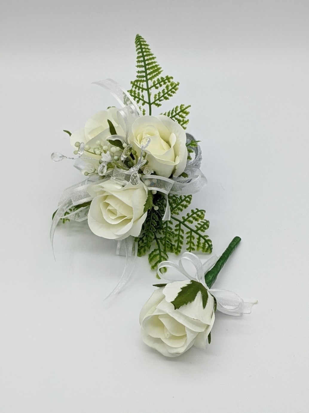 White Roses surrounded by Green Ferns centred with glass bead spray ...